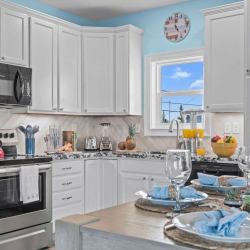 Bright, modern kitchen with chic decor and ocean views for culinary adventures!