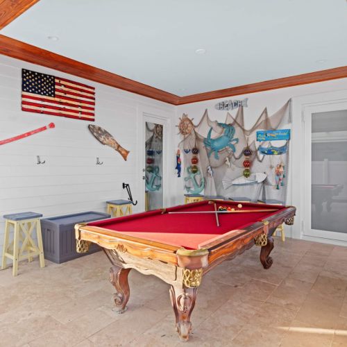 Unwind and challenge your friends in our cozy recreation room, featuring a sleek pool table perfect for friendly competitions.