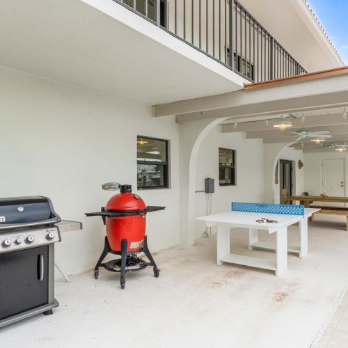Outdoor kitchen and grill zone with ping-pong and space to hang while the food hits the grill.