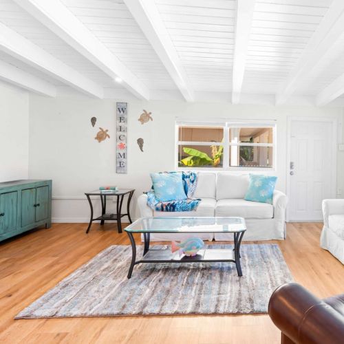 Step into comfort and style in our cozy living room, complete with stunning wood floors that add a touch of elegance. Relax on the plush sofa bed or enjoy movie nights by the window. Your perfect getaway awaits!