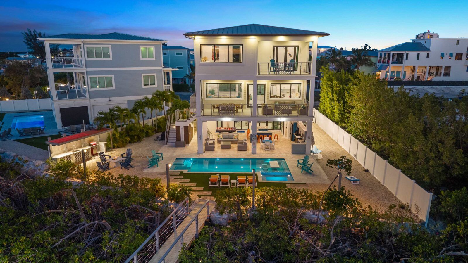 Three waterfront stories with a heated pool, outdoor lounge, and balconies on every level.