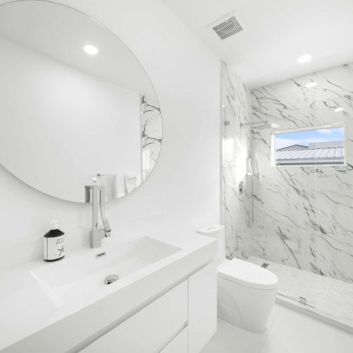 Indulge in a serene space featuring elegant marble accents and modern fixtures!