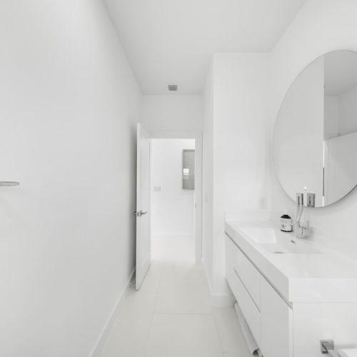 Bright, sleek design with modern fixtures and spacious vanities for a refreshing retreat!