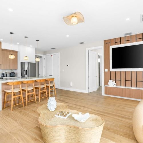 Spacious living area with large smart tv and seamless flow to the kitchen, made for movie nights and quality time with loved ones.