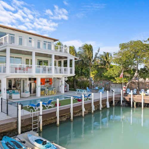 Just steps away from your cozy retreat, you’ll find a refreshing pool surrounded by lush greenery and the perfect backdrop of sky and clouds. Your vacation oasis awaits!