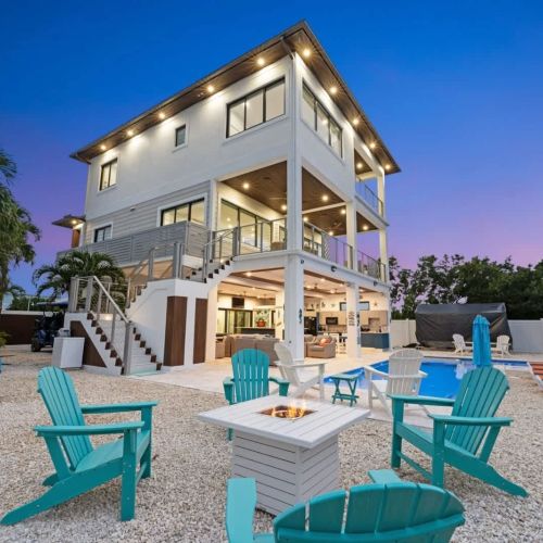 Outdoor view of seaside escape with bonfire pit and lounge chairs