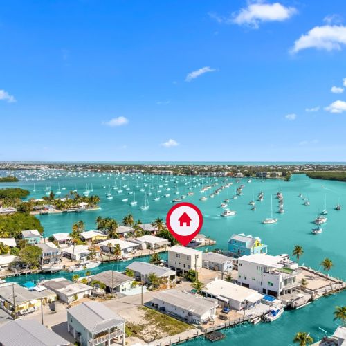 Discover vibrant island life with stunning water views and playful sailboats!