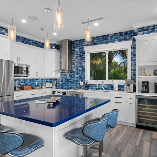 Step into this charming kitchen with its stunning blue countertop! Perfect for whipping up a feast or enjoying your morning coffee.