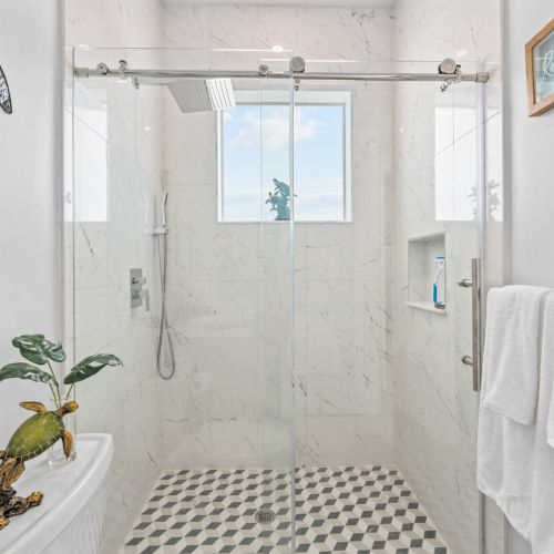 Customunwind under the shower after a day of exploration shower tiles add to the stylish design.