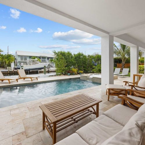 Poolside lounge: sink into cushioned teak seating steps from the pool and spa.