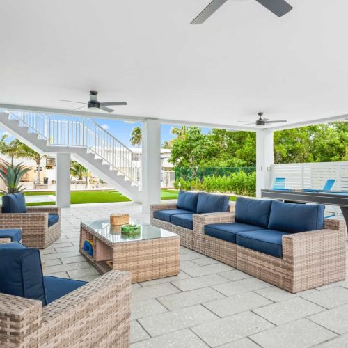 Spacious outdoor lounge with comfy seating and a big tv. Relax in the shade and stay connected to the pool vibes.