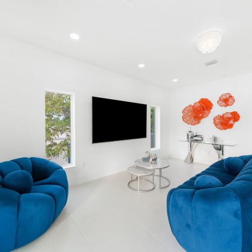 Bright and vibrant space with plush blue seating and modern decor, perfect for relaxation!