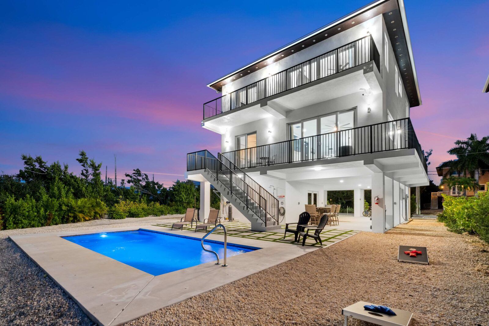 Glow into the night. Heated pool, cornhole, and cocktails under the balcony lights.