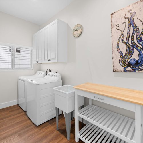 Laundry room: full-size washer and dryer with a folding station to keep trips light.