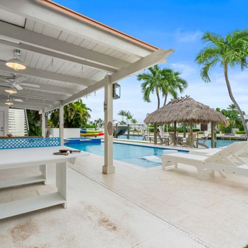 Outdoor bar and lounge area steps from the pool, perfect for snacks, drinks and hanging out between swims.
