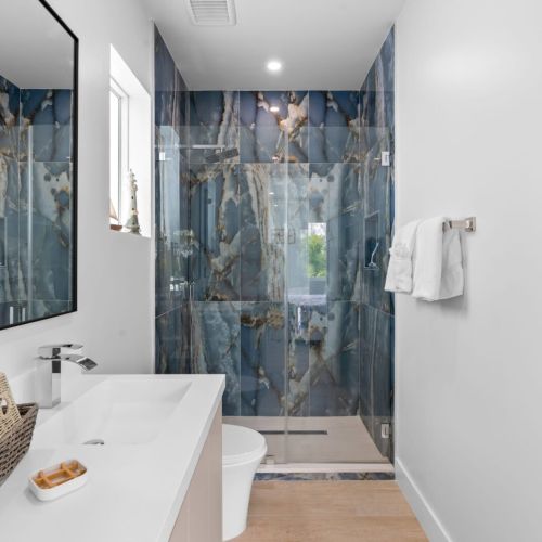 Indulge in relaxation with a soothing shower and a chic sink in this sophisticated bathroom oasis.