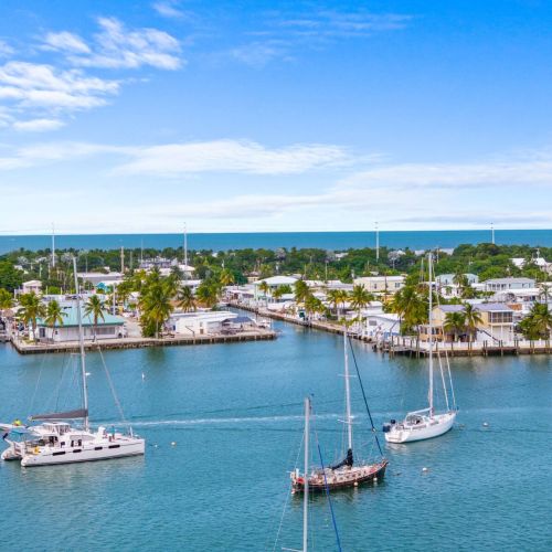 Experience the quintessential keys boating lifestyle with sailboats gliding by and endless opportunities to explore marathon's crystal-clear turquoise waters.