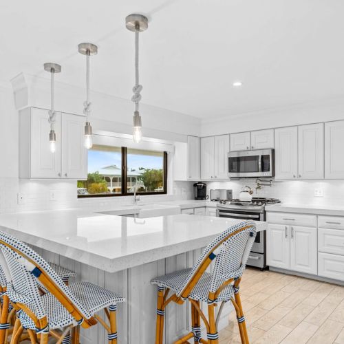 Huge island for cooking, cocktails and hanging out together with water views from the window.