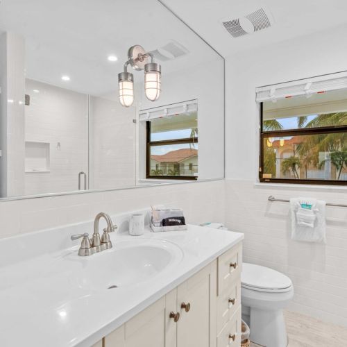 Bright bathroom with vanity and relaxing water views while you get ready.