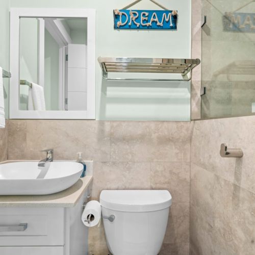Our sleek marble bathroom with a refreshing shower and elegant glass cover.