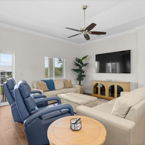 Living room: recliners facing the big screen, balcony and canal right beside you.