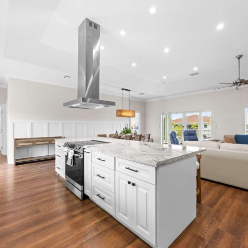 Open kitchen: the island runs from the range to the dining table to the bunk room.