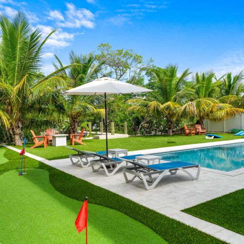 Private putting green meets tropical paradise. Perfect your short game, lounge poolside under the palms, or unwind by the firepit as the breeze rolls in. Every corner of this backyard invites play, relaxation, and sunshine-soaked memories.