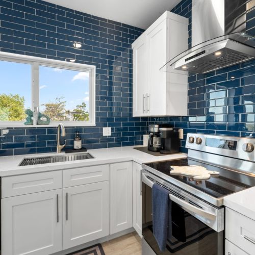 The modern cabinetry, stainless steel appliances, and thoughtful layout make cooking a breeze while maintaining a sleek aesthetic.