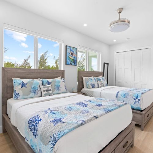 Experience the ultimate relaxation in this bedroom featuring not one, but two beds where you can binge-watch your favorite shows on the flat screen tv!