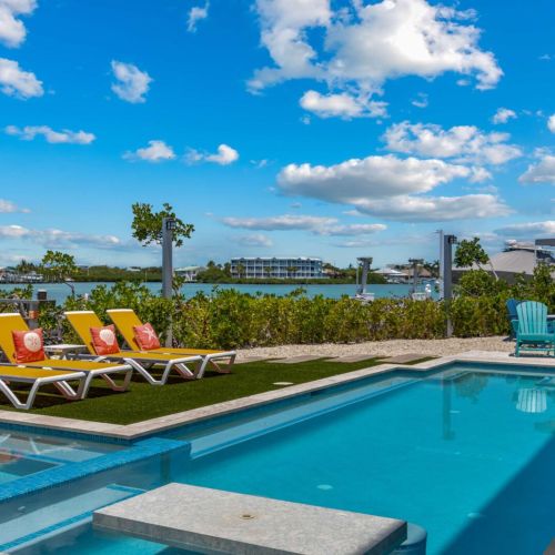 Seaside escape heated pool, built-in spa, and harbor views.