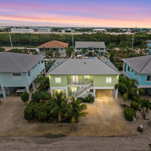 The neighborhood: a freshly finished home among classic keys cottages, bay just beyond.