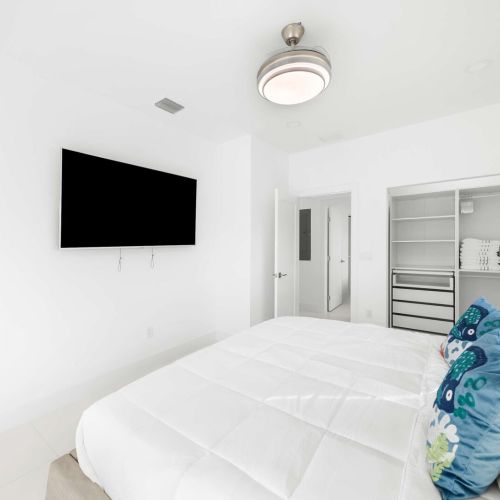 Bright and airy retreat with chic decor, a plush bed, and modern amenities for relaxation!