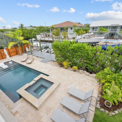 Pool & dock: heated pool and spa right at the canal's edge, with your dock just beyond.