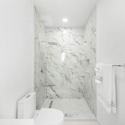 Step into this sleek marble shower for an invigorating escape after sun-soaked days!