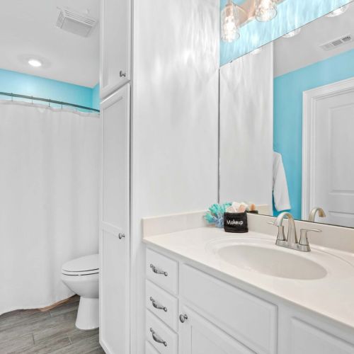 Dive into vibrant hues and sleek fixtures in this spa-like oasis!