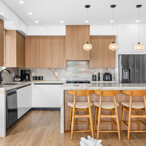 Stylish kitchen island with seating for the whole crew, perfect for morning coffee or casual meals between beach adventures.