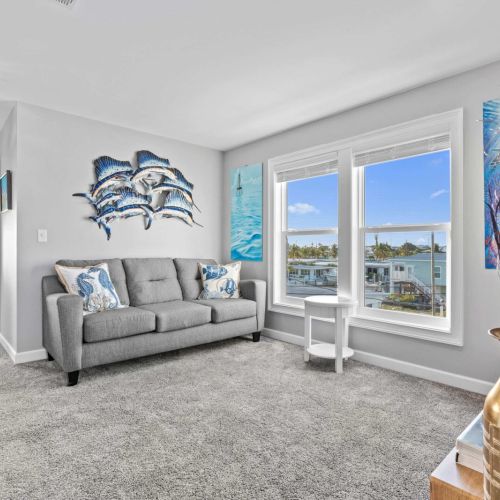 Bright and airy retreat with stunning views, ocean art, and plush seating for relaxation!