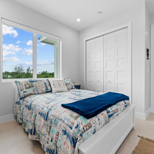 The bedroom basks in natural sunlight. Window blinds are there for guests who like to sleep longer in the morning.