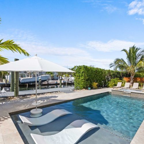 Pool & dock: heated pool and spa right at the canal's edge, with your dock just beyond.
