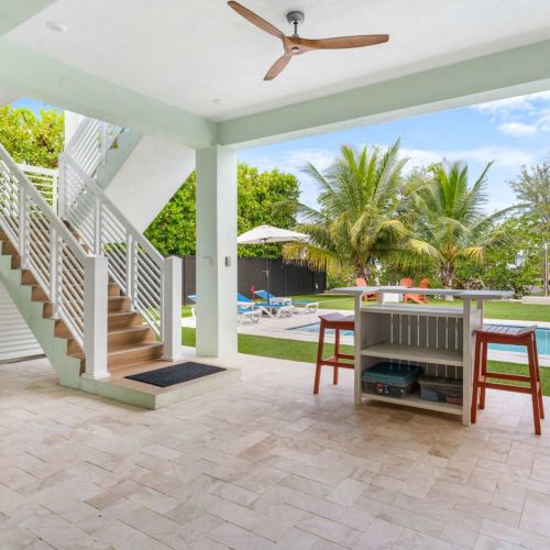 This shot captures the heart of emerald oasis living—an open-air lounge designed for easy island days. With its poolside bar, cozy seating, and breezy ceiling fans, this is where afternoons stretch into golden sunsets surrounded by palm shade and cal