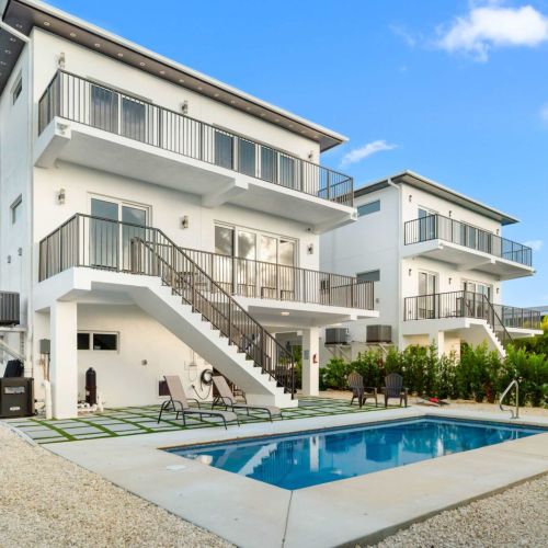 Your private slice of modern island living. Sparkling pool, sleek design, and endless sunshine just steps from the water.