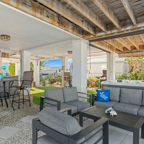 Chill out in style on plush seating with vibrant accents in this tropical retreat!