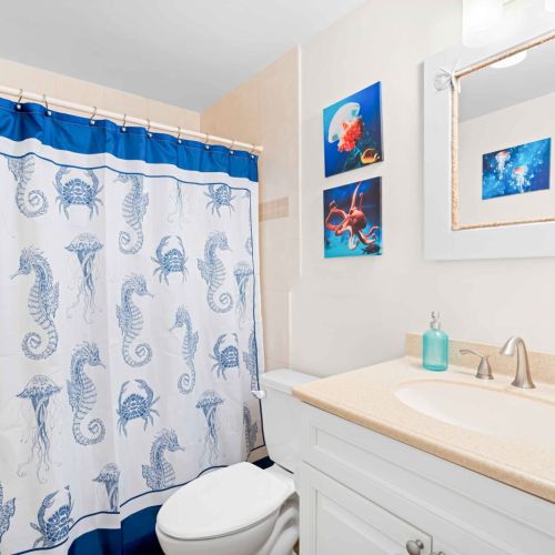 Our bathroom features a cheerful blue shower curtain that adds a splash of color to your stay. Enjoy the perfect blend of comfort and charm as you unwind after a day of adventure. Your relaxing retreat awaits!