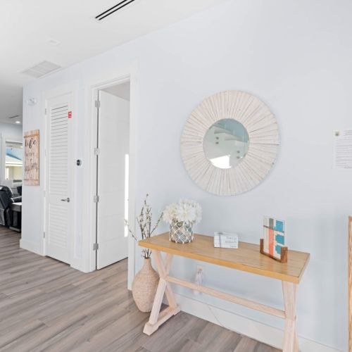 Relax in a room designed with a stunning mirror and a charming table, perfect for unwinding or planning your next adventure.