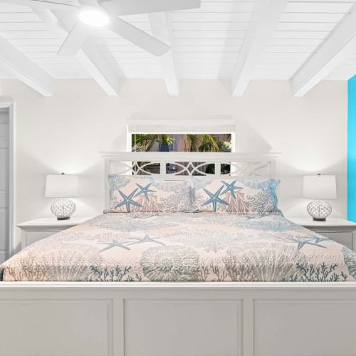 This charming bedroom invites you to relax and unwind. Sink into the plush bed, enjoy a good book in the chair, and let your worries float away.