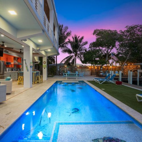 Relax and unwind on the patio with your favorite drinks in hand! Whether you're grilling up a feast or enjoying the shade under the palm trees, this is your perfect outdoor escape. Let the good times roll!