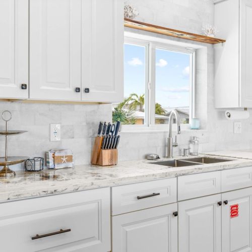 Kitchen sink: rinse the day's catch with the palms swaying through the window.