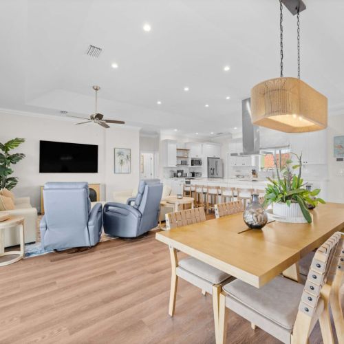 Great room: dining, lounge, and chef's kitchen all sharing one water-view space.