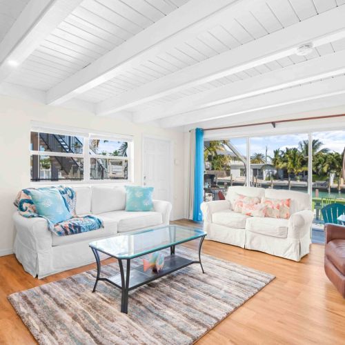 Welcome to your cozy retreat! This spacious living room features a large window that invites sunshine and good vibes. Kick back on the sofa bed or cuddle up with a coffee at the table—your perfect getaway starts here!