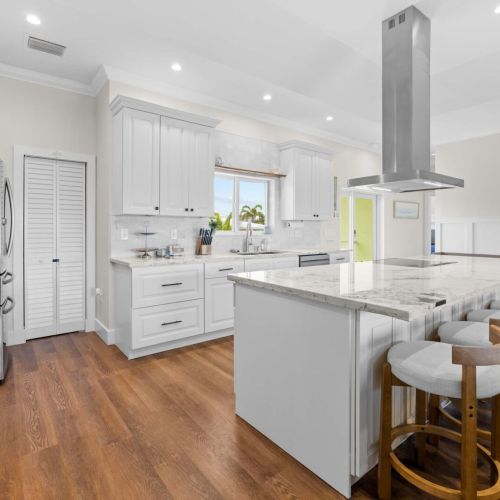 Kitchen island: sunlit marble and seating for the whole group where the action happens.